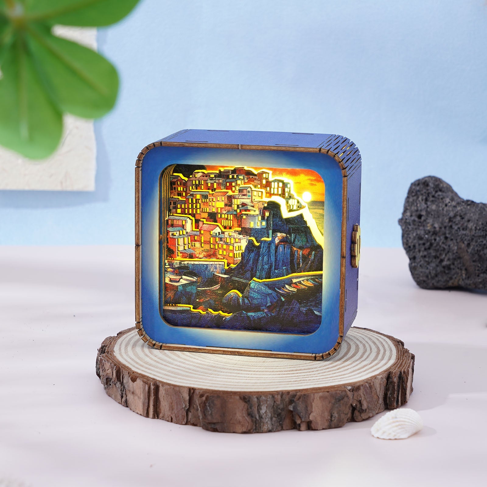 Golden Coast Village 3D wooden puzzle night light showcasing a colorful village at sunset, placed on a wooden base.
