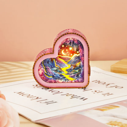 Dreamy Mine Cave Kit heart-shaped wooden puzzle night light illuminating a scenic landscape with mountains and rivers.