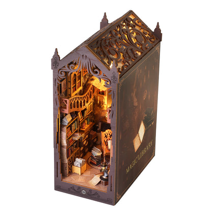 Magic House DIY Book Nook Kit showing intricate wooden puzzle design with books, lighting, and musical elements.