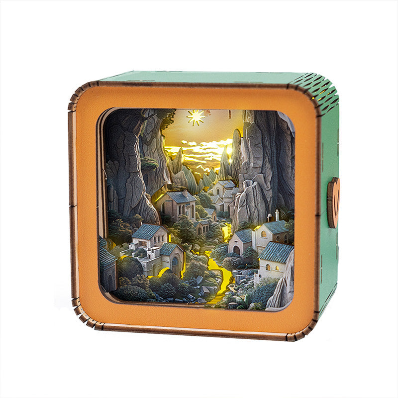 3D wooden puzzle night light illuminating a serene valley village scene with mountains and houses.