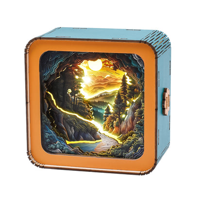 3D wooden puzzle night light featuring a sunset wilderness landscape with mountains, trees, and a river.