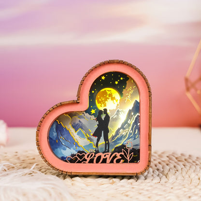 Heart-shaped 3D wooden puzzle night light featuring a romantic silhouette under a moonlit sky.