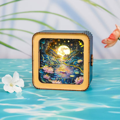 3D wooden puzzle night light featuring a moonlit lotus pond scene with glowing stars and water lilies.