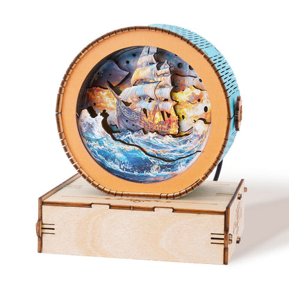 Decorative wooden music box featuring a ship sailing through waves with vibrant colors and intricate design.