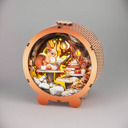 3D wooden puzzle night light featuring a squirrel reading, surrounded by autumn foliage and a cozy setting.