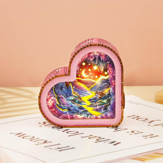 Heart-shaped 3D wooden puzzle night light showcasing a colorful cave and river scene, ideal for home decor.
