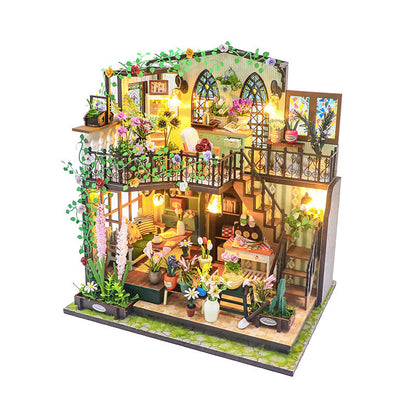 Daisy's Flower Room DIY dollhouse kit showcasing detailed miniature design with plants and lighting.