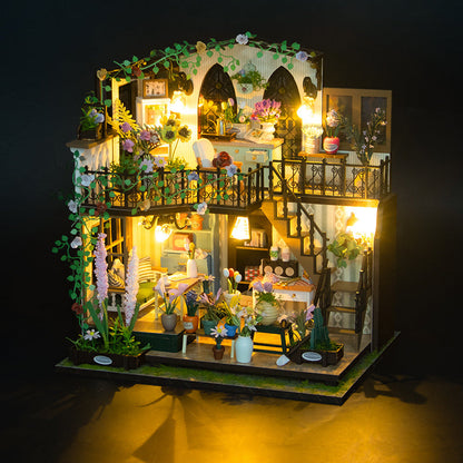 Daisy's Flower Room DIY Dollhouse Kit illuminated with colorful flowers and intricate furniture, showcasing a charming miniature interior.