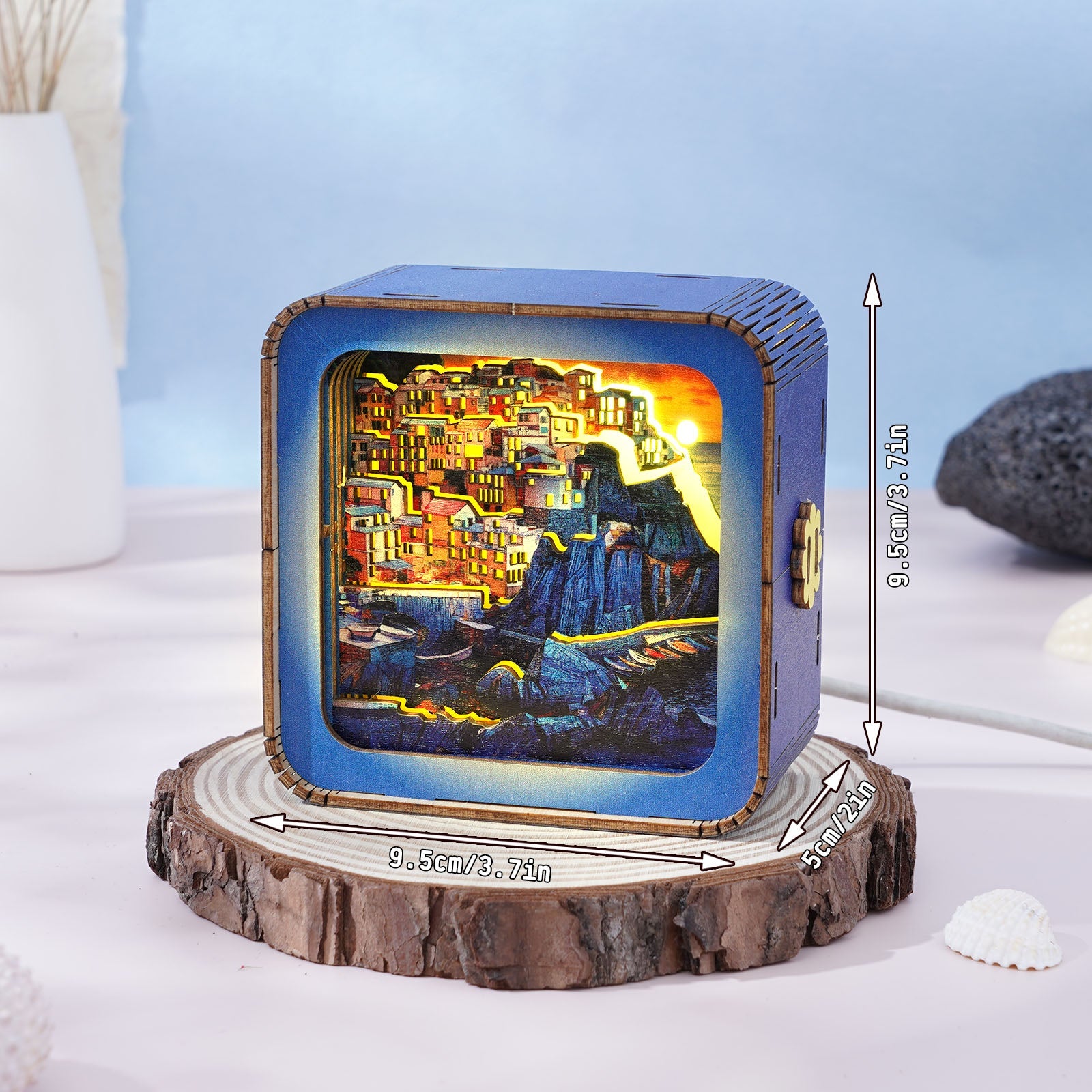 Golden Coast Village 3D wooden puzzle night light displayed on a wooden slice, featuring a colorful illuminated scene with dimensions.